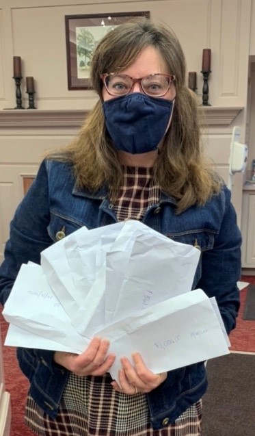 First Selectman Melissa Mack with envelopes to calculate donations to SCA