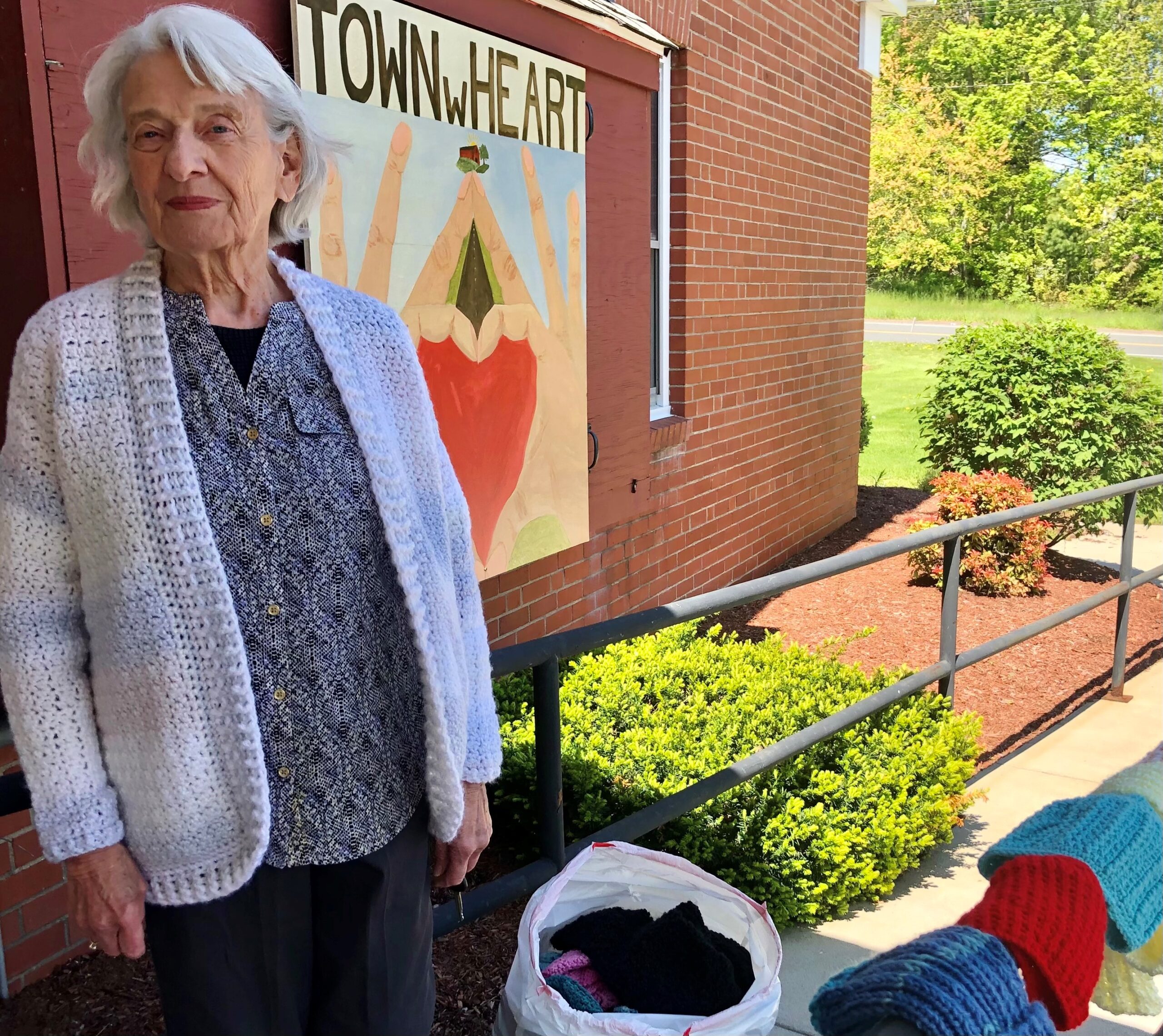 Joann Pawelcik with some of her knitted gifts to donate